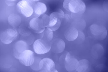 Defocused trendy violet glittering background with shinig bokeh.