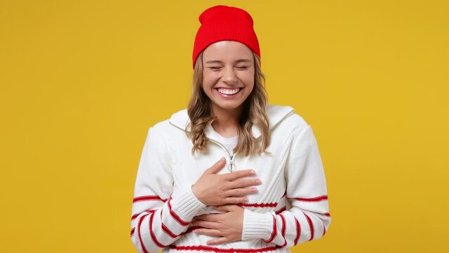 Excited cheerful fun young girl teen student wears striped white shirt hat look camera laugh smiling watch comedy movie pointing index finger on you isolated on plain yellow background studio portrait