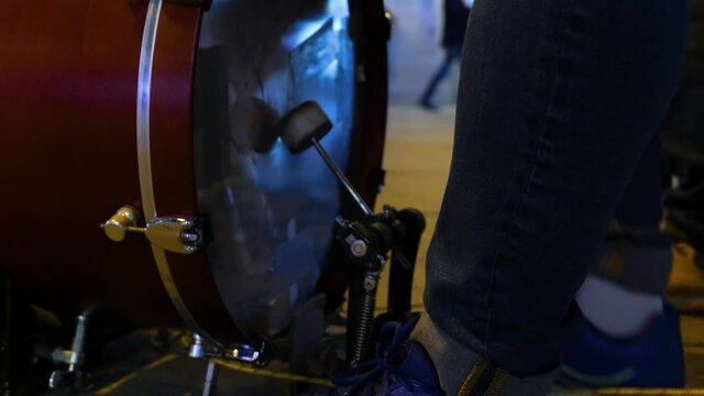 foot of a street musician playing the bass drum