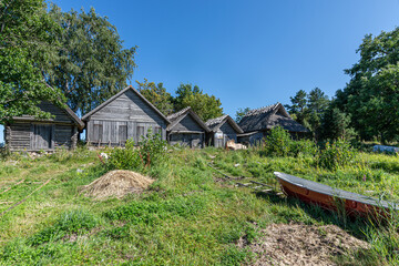 Idyllic wooden historic houses with thatched roof in Altja fishing village, northern Estonia