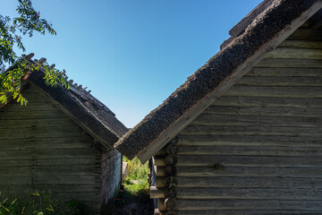 Fototapeta na wymiar Idyllic wooden historic houses with thatched roof in Altja fishing village, northern Estonia