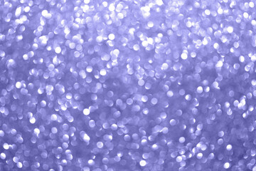 Very Peri. Color of the year 2022. Abstract background toned trendy color 2022. Sparkle lights and bokeh. Useful as New Year background or greeting card. Festive Blurred Backdrop.