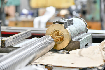 Machine lead screw with bronze nut for equipment repair. - obrazy, fototapety, plakaty
