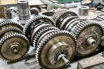Obraz premium Disassembled gearbox with clutch discs of a metalworking machine. Mechanical equipment repair shop.