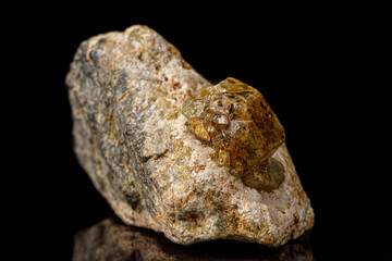 Macro stone Grossular mineral on a black background