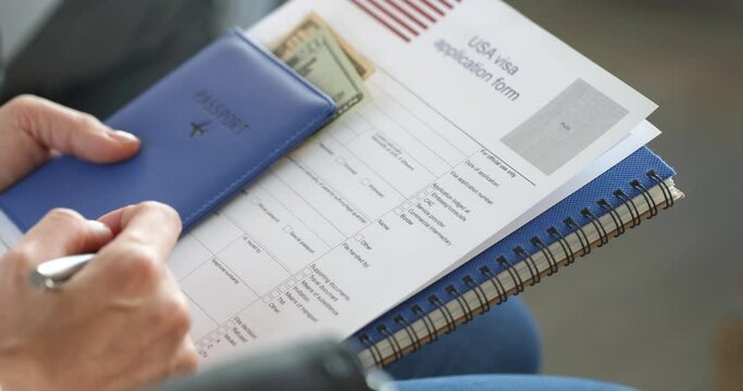 People sitting in line with documents to obtain american visa closeup 4k movie slow motion