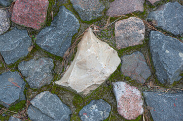 stone wall with green moss in the joints