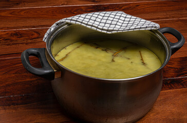Making of marijuana green salve on wooden brown table