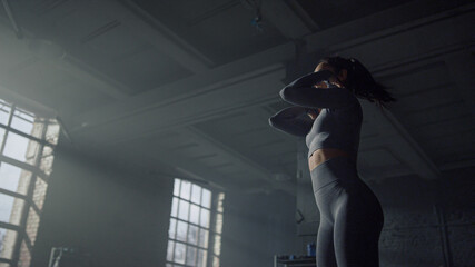 Girl doing warming exercise for neck. Woman preparing muscles for training