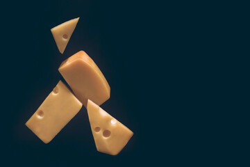 Slicing cheese, flying food cheese with black background, copy space on the right