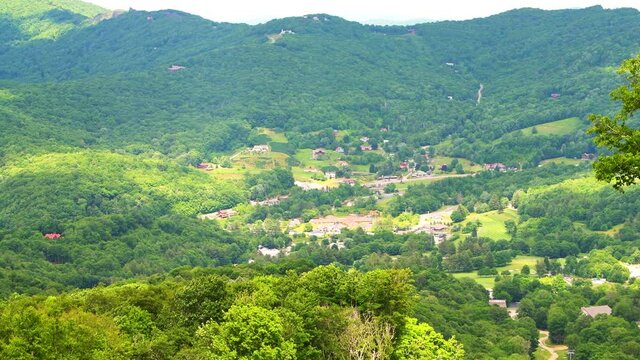 Cityscape high angle aerial view zoom zooming in of Banner Elk town city in summer in North Carolina in Blue Ridge Appalachian from Sugar Mountain ski resort in NC