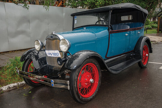 Gramado, Brazil - July 23, 2019. Antique Ford 1929 car in perfect condition, parked on a rainy day in a street of Canela. A charming small town very popular by its ecotourism.
