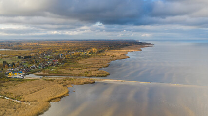 Fototapeta na wymiar Aerial view to the autumn colored shallow and sandy coastal zone of the Lake Peipsi, in Varnja, Estonia. It is the 4th largest lake in Europe