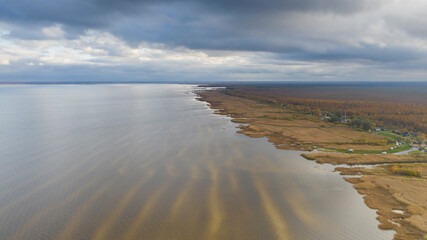 Aerial view to the autumn colored  shallow and sandy  coastal zone of the Lake Peipsi, in Varnja, Estonia. It is the 4th largest lake in Europe