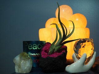 A salt lamp with a candle holder with the words peace
