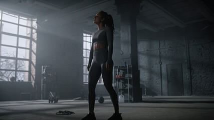 Woman walking in gym after training. Sportswoman relaxing between exercises 