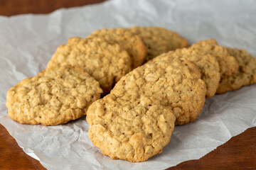 Home Backed Oatmeal Cookies in Two Rows on Parchment Paper