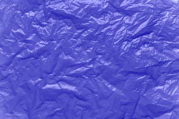Abstract background. Crumpled plastic surface. Color of the year 2022 Very Peri.