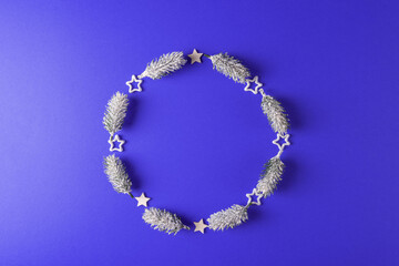 Christmas tree frosty brunches on blue background arranged as a circle. New Year and Christmas design concept