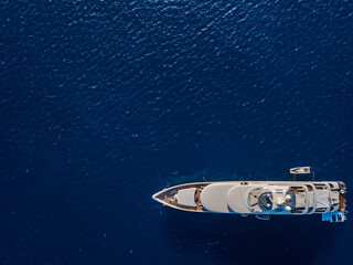 Aerial view on white yacht in blue sea