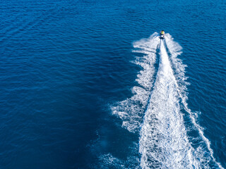 View from drone of jet ski in azure sea. Water sport