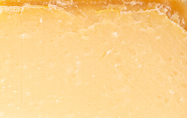 Parmesan cheese slice texture background.