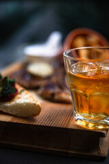 a glass of whiskey on a steak background