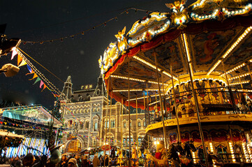 The city is decorated for Christmas. Christmas Fair and Two-Story Carousel in Moscow on Red Square.