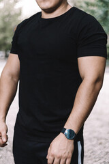 Fototapeta premium a male athlete without a face in a black T-shirt