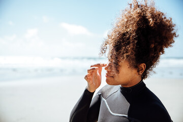 Woman applying sunscreen on the beach