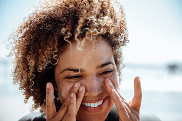 Woman applying sunscreen on the beach