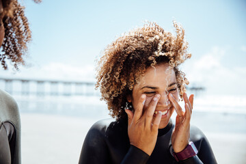 Woman applying sunscreen on the beach