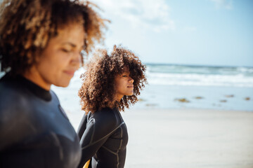 Black Woman carrying a surfboard