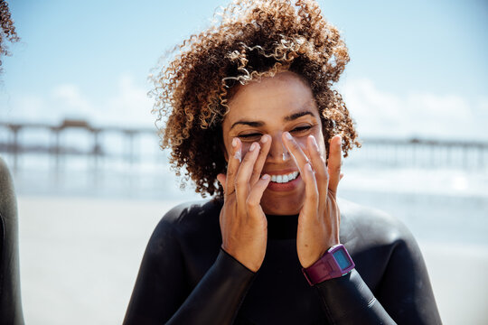 Woman applying sunscreen on the beach