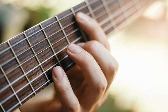 Close-up of hands playing guitar