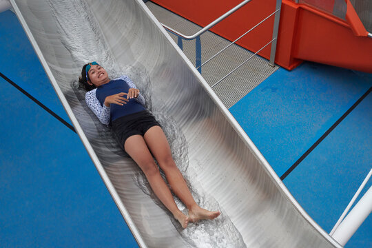 Young girl enjoying fun waterslide