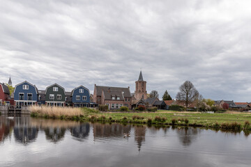 Church and colored houses in the village of Bunschoten-Spakenburg. 