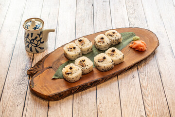 great tray of uramaki caterpillar sushi with prawns, wasabi, ginger, soy sauce and ripe avocado
