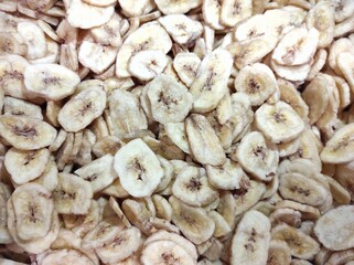 textured background of dried banana chips, banner