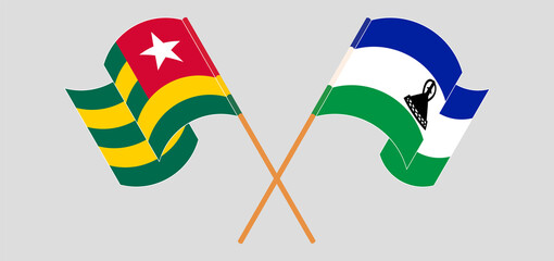 Crossed and waving flags of Togo and Kingdom of Lesotho