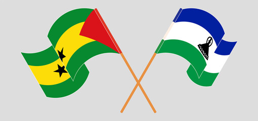 Crossed and waving flags of Sao Tome and Principe and Kingdom of Lesotho