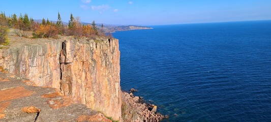 Stunning Red Toned Sheer Cliffs with a Steep Drop Off to Clear Waters Below; Travel, Hiking,...
