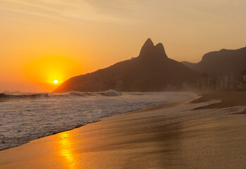 Ipanema Beach, Brazil on a Sunset at summer. Two Brothers Mountain on background with beautiful...