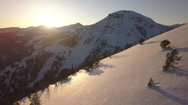 sunset on snow covered mountainside 