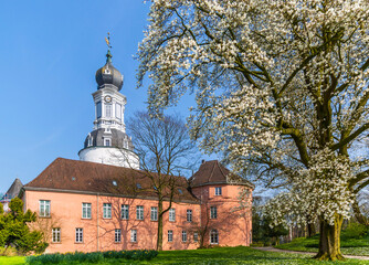 Jever Castle Museum and magnolia blossom in spring, Germany