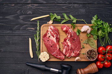 meat on wooden board vegetables and ingredients for cooking wooden background