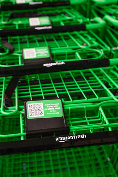 Bellevue, WA, USA - September 06, 2021; Green grocery carts close up outside the Amason Fresh location in Factoria Washington, a neighborhood in Bellevue