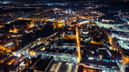 Fototapeta na wymiar Panorama of a brightly lit northern European city at night from a height