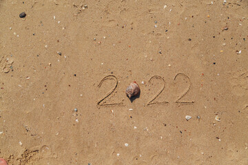 Word 2022 Written on the Sand of a Beach. Copy Past Space.