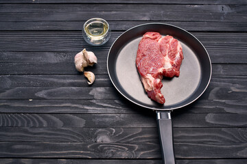 meat steak in a frying pan food ingredients kitchen wooden table
